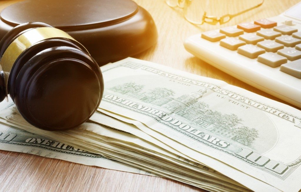 Wooden gavel on top of stack of cash