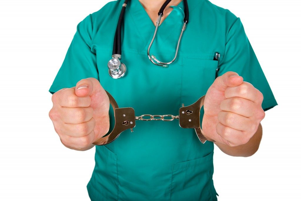 surgeon wearing handcuffs