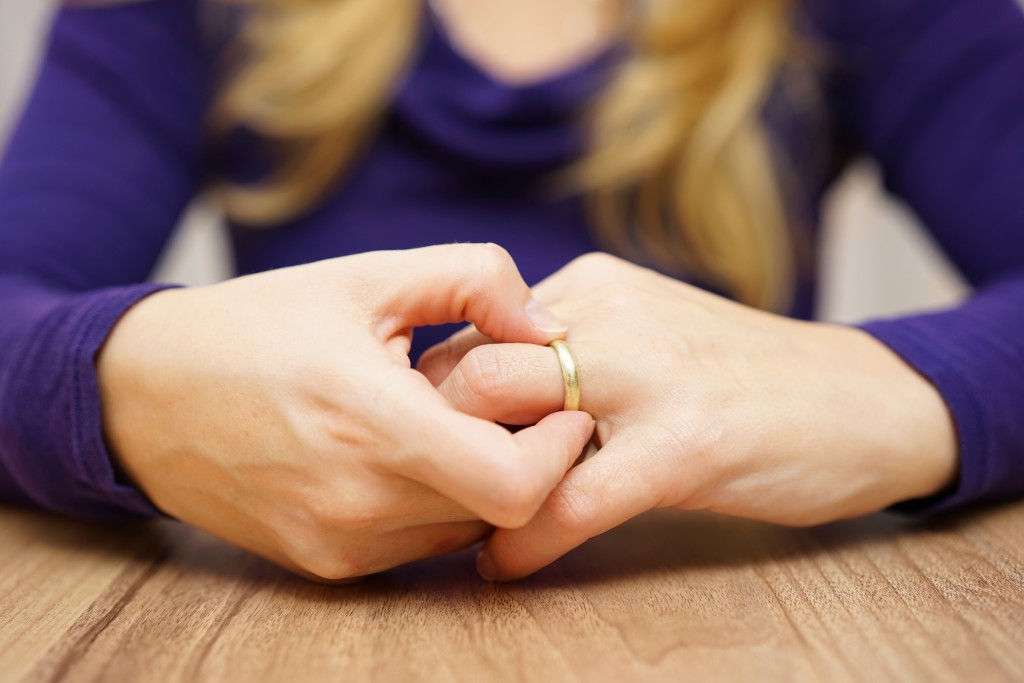 Woman removing her wedding ring