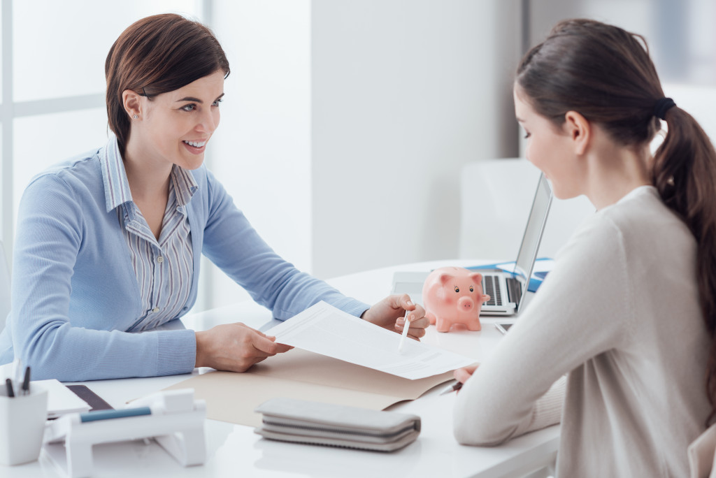 A financial advisor showing some documents to a client in an office