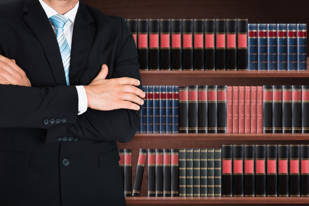 closeup of male lawyer standing in front of book shelf