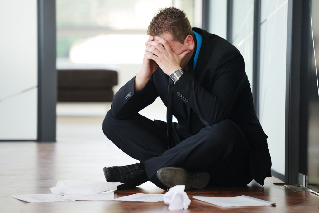 exhausted businessman sitting on the floor